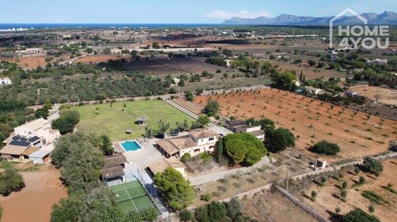 Luftaufnahme mediterraner Finca in Santa Margalida mit Pool, Padelplatz und großem Grundstück, Meerblick