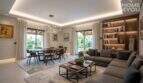 Lichtdurchflutetes Wohn-Esszimmer mit Ringlampen, grauem Sofa, Bücherregal und Gartenblick, Finca Lloseta