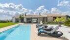 Mediterranean finca in Sa Pobla: panorama pool with sun loungers and natural stone main house
