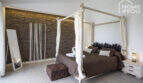 Bedroom of the finca with canopy bed, stone wall and Mediterranean ambience, Sa Pobla