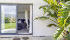 Terrace with tropical plants and view into elegant bedroom with canopy bed, Mediterranean finca Sa Pobla