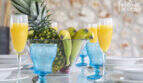 Set dining table of the finca with fruit bowl, blue glasses and fresh juices – Mediterranean ambience.