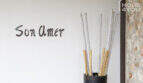 Entrance area of the finca Son Amer with decorative bamboo arrangement and Mediterranean natural stone wall in Sa Pobla.