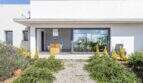 Mediterranean finca in Sa Pobla: modern exterior with panoramic glazing, terrace and Mediterranean garden