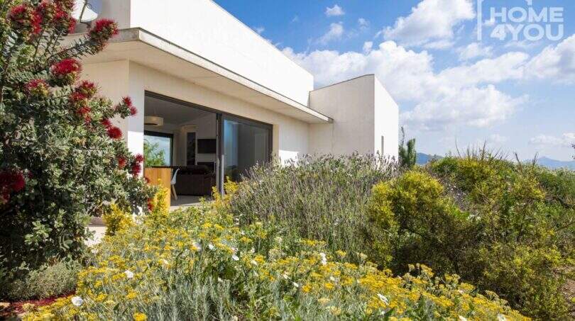 Mediterranean finca Sa Pobla: exterior view with wildflower garden, lavender and large terrace sliding door