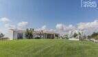 Mediterranean finca Sa Pobla: extensive lawn, pool area with lounge bed, single-story villa with terrace