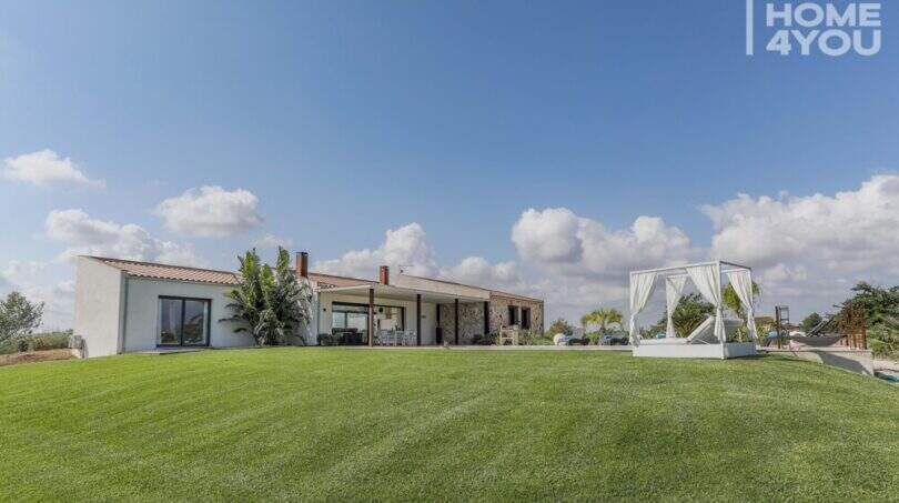 Mediterranean finca Sa Pobla: extensive lawn, pool area with lounge bed, single-story villa with terrace