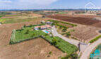 Aerial view Mediterranean finca Sa Pobla: villa with pool, guest house, lush garden & fruit trees on 24,000 m²