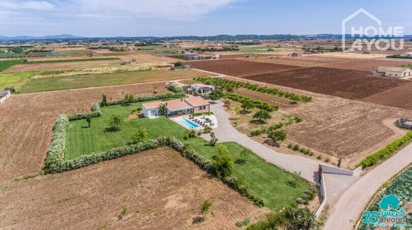 Aerial view Mediterranean finca Sa Pobla: villa with pool, guest house, lush garden & fruit trees on 24,000 m²