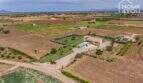 Aerial view of the Mediterranean finca in Sa Pobla with pool, green spaces and separate guest house on 24,000 m²