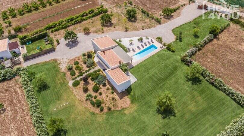 Aerial view Mediterranean finca Sa Pobla: white country house, panoramic pool, manicured lawn, 24,000 m² property