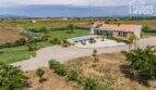 Aerial view Mediterranean finca Sa Pobla: pool, stone house, expansive property, panoramic mountain views