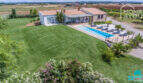 Aerial view Mediterranean finca Sa Pobla: expansive garden, panoramic pool with loungers, terrace & stone house
