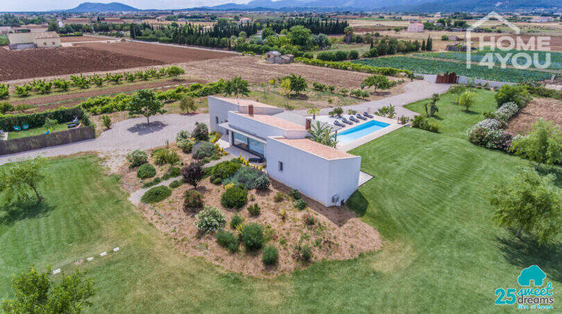 Aerial view Mediterranean finca Sa Pobla: modern country house with pool, expansive garden & mountain views