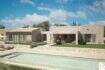 Exterior view of an exclusive finca in Artà with a pool, natural stone walls, and Mediterranean charm