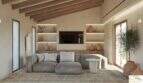 Luminoso salón de la Finca Artà con techo de vigas de madera, estantería empotrada, sofá gris y enlucido de piedra natural de estilo mediterráneo.