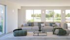 Helles Wohnzimmer der Finca Cala Murada mit großer Eckcouch, Panoramafenstern und Blick in den Garten