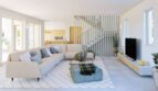 Helles Wohnzimmer mit Sofa, TV-Wand und offener Küche in der Finca mit Meerblick in Cala Murada
