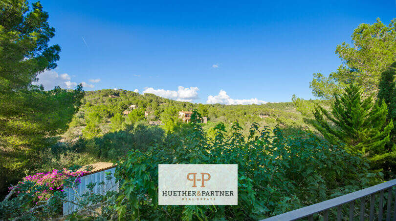 Blick vom Balkon der Finca Son Macià auf üppige Grünlandschaft mit bewaldeten Hügeln und Nachbarvillen