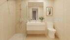 Modern bathroom of a new apartment in Palmanova with walk-in shower, sink and toilet in light tones.