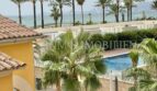 Balcony view of pool, palm trees and Mediterranean of the sea view apartment in Las Maravillas, Palma de Mallorca