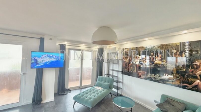 Bright living room with turquoise furniture, wall art, TV and balcony access in sea view apartment Palma
