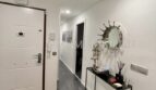 Bright entrance area of the sea view apartment in Las Maravillas with modern console table and decorative mirror.