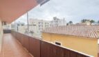 Spacious balcony with bamboo privacy screen and view of neighboring buildings and palm trees in Las Maravillas, Palma