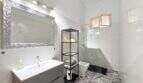 Helles Badezimmer mit Glasdusche, Waschtisch, Wandspiegel und Zementfliesen in Wohnung Felanitx