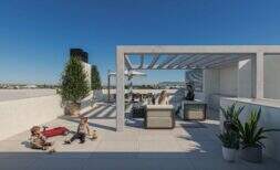 Sunny roof terrace of the penthouse in Porto Cristo with pergola, lounge, kitchen and wide view over the city