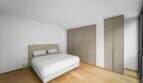 Helles Schlafzimmer der Luxuswohnung am Paseo Marítimo mit Doppelbett, Parkettboden und modernen Einbauschränken.