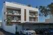 Modern multi-family house in Porto Cristo with balconies, wood accents, greenery and covered parking spaces