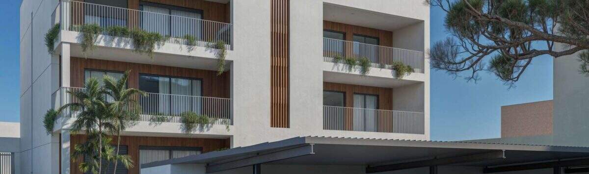 Modern multi-family house in Porto Cristo with balconies, wood accents, greenery and covered parking spaces