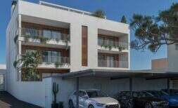 Modern multi-family house in Porto Cristo with balconies, wood accents, greenery and covered parking spaces