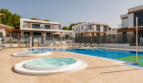 Moderne Doppelhaushälfte in Cala Ratjada mit großem Pool, Whirlpools und Sonnenliegen auf gepflegter Terrasse.
