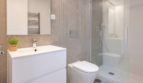 Modern Bathroom of the Semi-Detached House in Cala Ratjada with Glass Shower, WC and White Vanity Cabinet