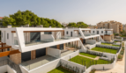 Modern semi-detached houses in Cala Ratjada with glass railings, wood accents and well-maintained green spaces.