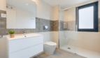 Modern Bathroom of the Semi-Detached House in Cala Ratjada with Glass Shower, WC and White Vanity