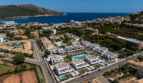 Aerial View of Modern Semi-Detached Houses in Cala Ratjada with Pool, Sea View and Green Surroundings.