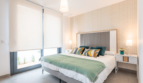 Bright Bedroom of the Semi-Detached House in Cala Ratjada with Double Bed, Green Bedspread and Large Window