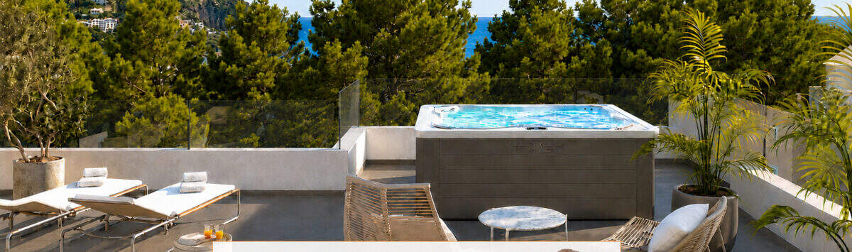 Penthouse Canyamel: Luxus-Dachterrasse mit Whirlpool, Sonnenliegen und Meerblick zwischen Pinien.