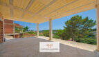 Überdachte Terrasse im Rohbau mit Blick auf Pinien, umliegende Villen und Meer in Cala Romántica