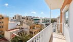 Sonniger Balkon eines Penthouses in Palma de Mallorca mit Stadtpanorama und blauem Himmel.