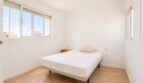 Helles Schlafzimmer im Penthouse Palma de Mallorca mit Doppelbett, weißen Wänden und Fliesenboden