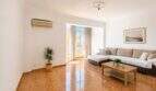 Bright living room with terracotta floor, corner sofa, air conditioning and balcony access in Palma-Camp Redó