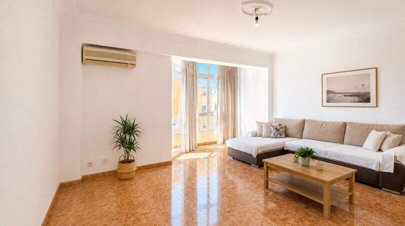 Bright living room with terracotta floor, corner sofa, air conditioning and balcony access in Palma-Camp Redó
