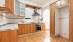 Bright kitchen with wooden fronts, built-in oven, range hood and arched window in apartment in Palma-Camp Redó