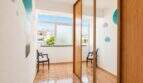 Bright children's room with built-in wardrobe, mirror door, colorful wall stickers and view of Palma-Camp Redó