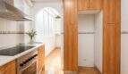 Bright kitchen with wooden fronts, ceramic hob, oven, extractor hood and large pantry in Palma