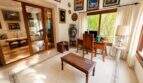 Elegant study of the Llucmajor finca with wooden furniture, artwork and view of the garden
